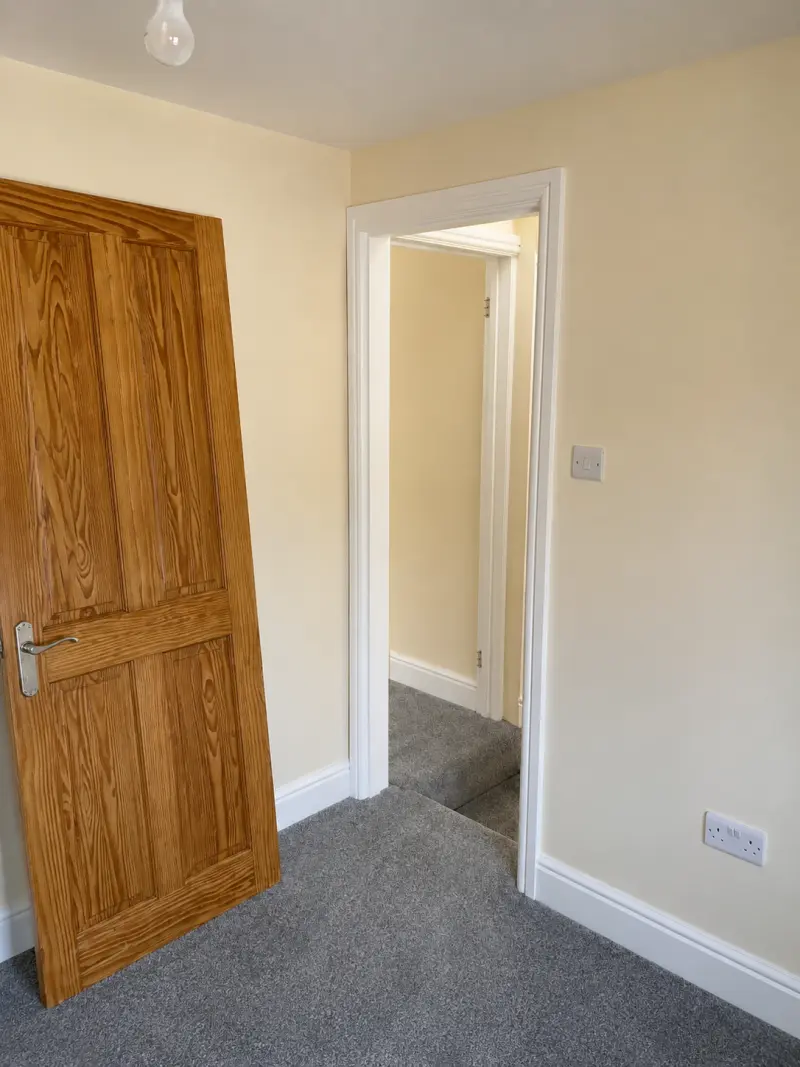 Internal timber door trimmed to clear newly fitted carpet and close properly
