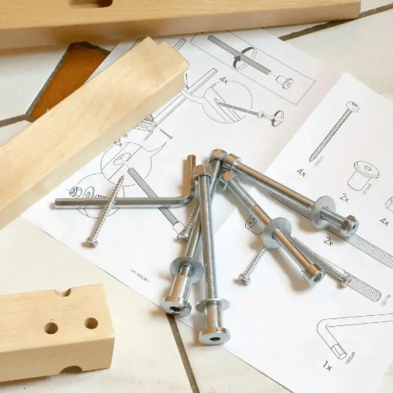 Bolts on a desk with a plan